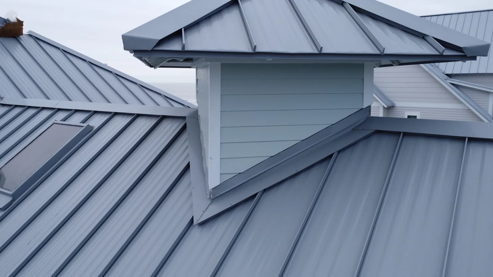 Standing seam flashing around a cupola